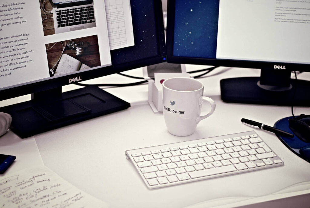 Modern workspace, coffee, Dell computers.