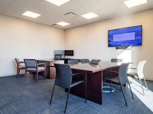 Modern conference room with Zoom meeting.