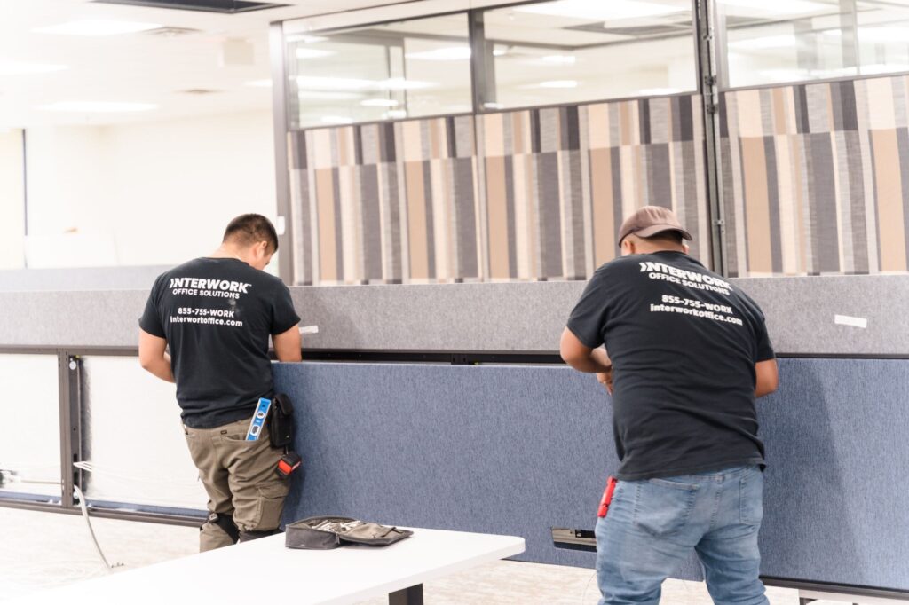 Workers installing office partitions.