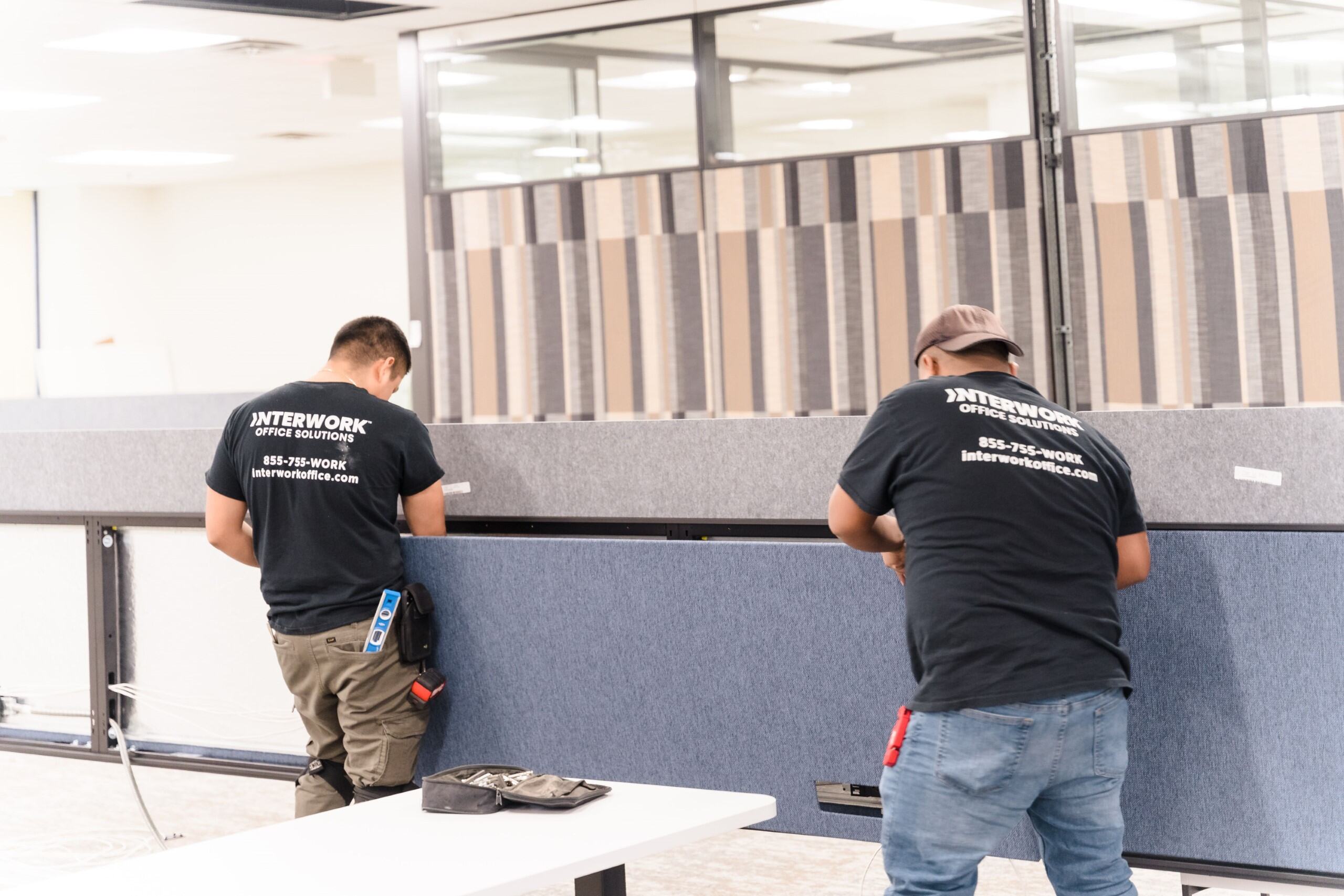 Workers installing office partitions.