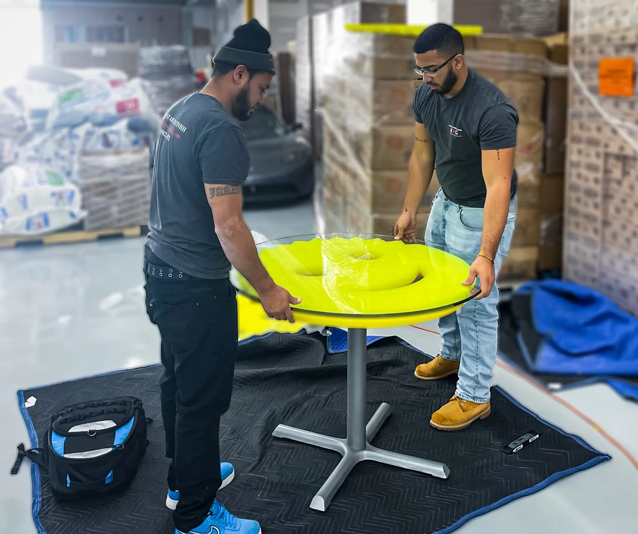 Men installing yellow smiley table.
