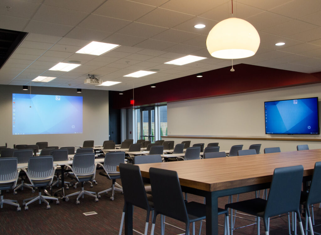 Modern classroom with large screens.